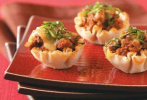 Gourmet beef-filled wonton cup appetizers garnished with green onions, ready for foodservice and wholesale distribution.