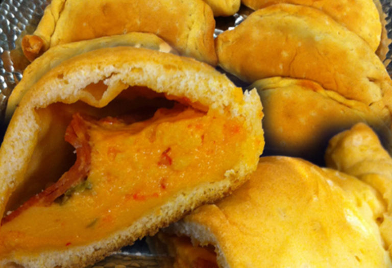 Golden-brown fried pastry pockets with savory filling, ideal for wholesale food suppliers and commercial foodservice distribution.