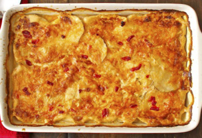 Golden-brown baked potato au gratin with pimento cheese in commercial foodservice pan, ideal for wholesale food distribution and bulk catering.